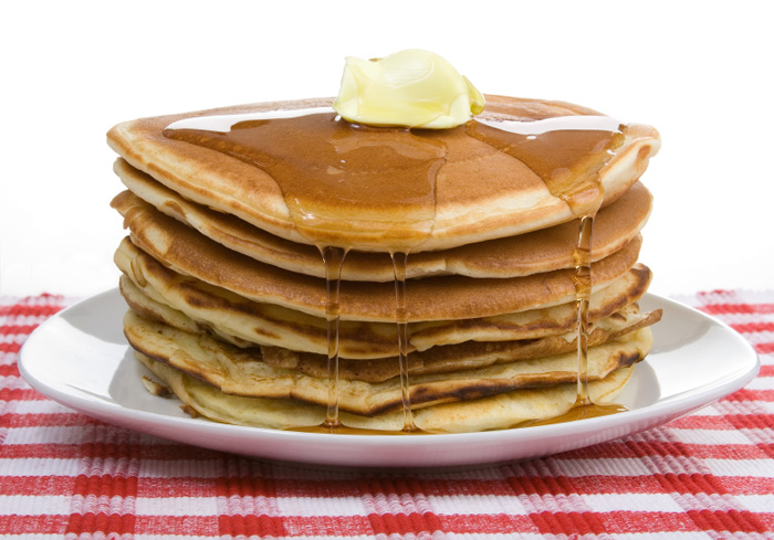 [stack of pancakes with butter and syrup]